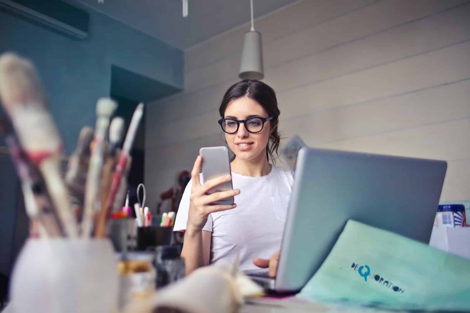 Girl using phone and computer